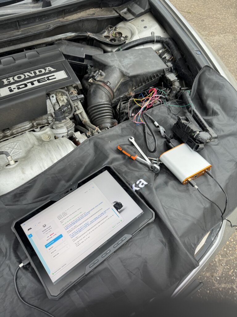 A tuning tool and tablet connected to a car on a real remap job